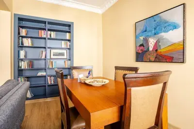 a dining room with a wooden table and chairs at Charming New 1BD Home - Close to Shoreline! #395 in Sarıyer