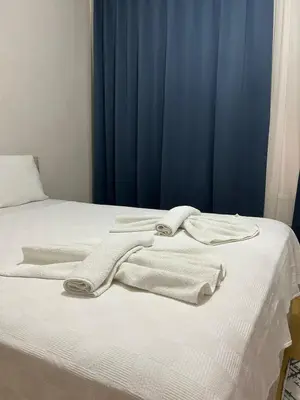 a bed with white towels on top of it at Apartment Taksim-Beyoğlu 2 in Istanbul
