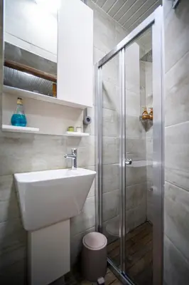 a bathroom with a sink and a shower at Mercan Apartments Balat - Mihrab Niche in Istanbul