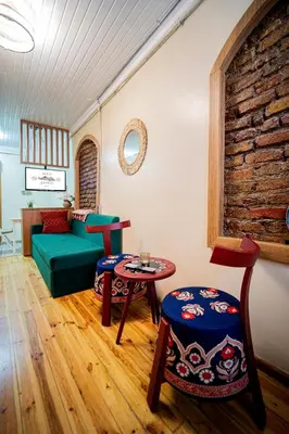 a living room with a green couch and a table at Mercan Apartments Balat - Mihrab Niche in Istanbul