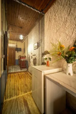 a room with a refrigerator and a table with a plant at Mercan Apartments Balat-The Bay in Istanbul