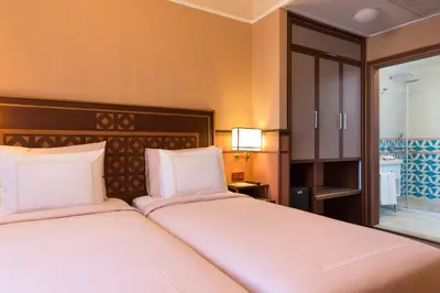 a hotel room with two beds and a window at Lalahan Hotel in Istanbul