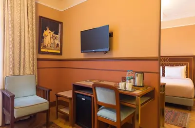 a hotel room with a desk and a bed and a television at Lalahan Hotel in Istanbul