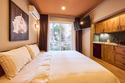 a large bed in a room with a window at Tare Suites Beşiktaş in Istanbul