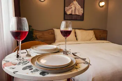 a table with plates and wine glasses on a bed at Tare Suites Beşiktaş in Istanbul