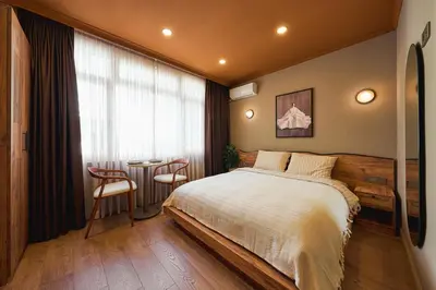 a bedroom with a bed and a table and a window at Tare Suites Beşiktaş in Istanbul