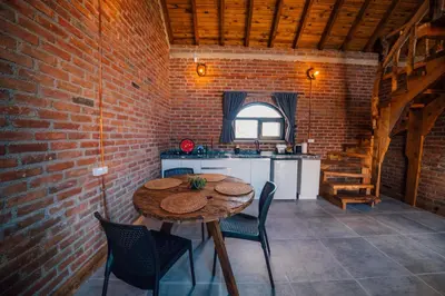 a dining room with a table and a brick wall at oasis sapanca in Sapanca