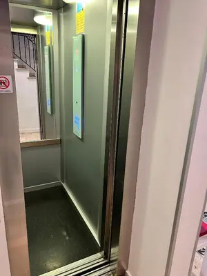 a elevator in a train with a glass door at T & R İstanbul hotel in Istanbul