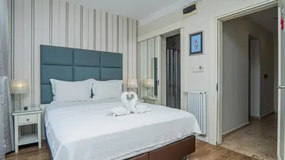 a bedroom with a large bed with a stuffed animal on it at T & R İstanbul hotel in Istanbul