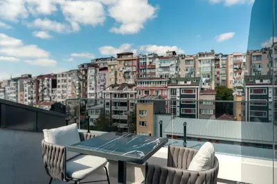 a balcony with a table and chairs and a city at Hampton By Hilton Istanbul Sisli in Istanbul