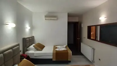 a hotel room with a bed and a tv at Hotel Çağyiğit in Istanbul
