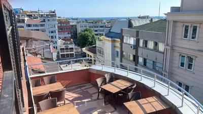 a balcony with tables and chairs on a building at Hotel Çağyiğit in Istanbul