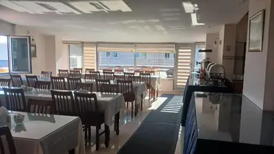 a dining room with tables and chairs in a room at Hotel Çağyiğit in Istanbul