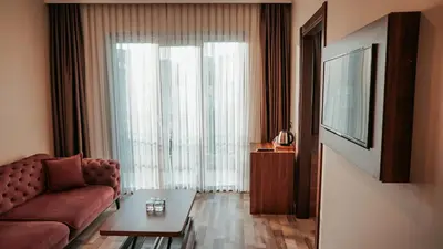 a living room with a couch and a table at The Grand Mira Business Hotel in Istanbul