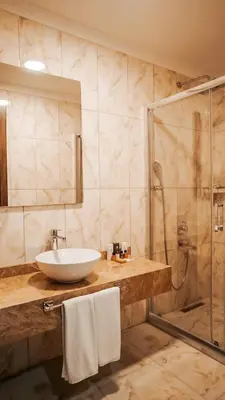 a bathroom with a sink and a shower at The Grand Mira Business Hotel in Istanbul