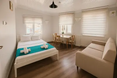 a bedroom with a bed and a couch and a table at Istanberry - Joker Two Bedroom Apartments in Istanbul