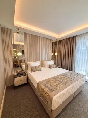 a bedroom with a large bed and a mirror at Saygın Hotel Beşiktaş in Istanbul