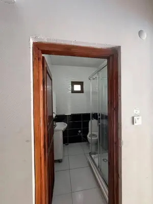 a bathroom with a toilet and a glass door at Sapanca Bizim Konak in Sapanca
