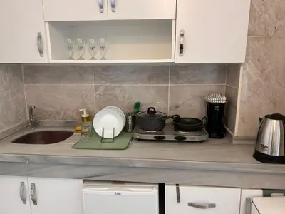 a kitchen counter with a sink and a stove at i1 House Hotel with Lovely Seaview Terrace in Istanbul