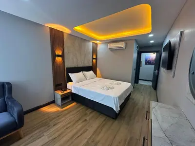 a small room with a bed and a chair at Dual Hotel Halkalı in Istanbul