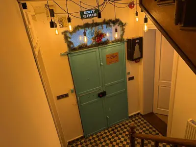 a hallway with a green door with a sign on it at Galata Tower Suites in Istanbul