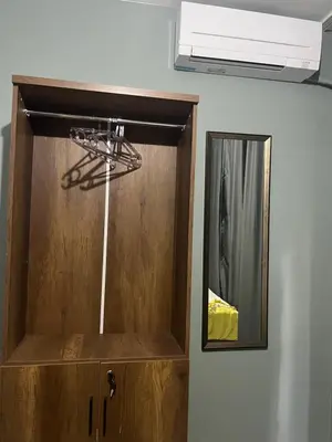 a wooden cabinet with a mirror in a room at Murat bey konağı in Istanbul
