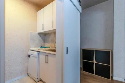 a kitchen with white cabinets and a window at Equipped Flat w Balcony - In The Arnavutköy - Bebek in Istanbul