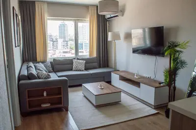a living room with a couch and a tv at Luxe Suite AI28 in Esenyurt