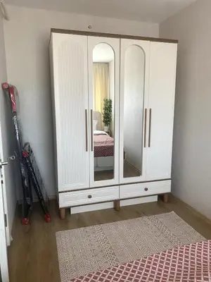 a bedroom with a white cabinet with a mirror at Luxe Suite AI28 in Esenyurt