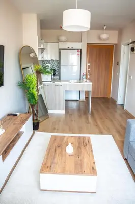a living room with a table and a kitchen at Luxe Suite AI28 in Esenyurt
