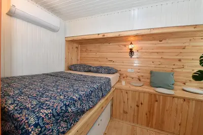 a bedroom with a bed and a wooden wall at Turkish Hammam 3 BR Historical Flat 3 AC in Istanbul