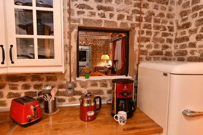 a kitchen with a counter top with a white refrigerator at Turkish Hammam 3 BR Historical Flat 3 AC in Istanbul