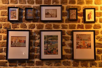 a group of framed pictures on a brick wall at Turkish Hammam 3 BR Historical Flat 3 AC in Istanbul