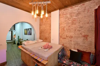 a bedroom with a bed and a brick wall at Wooden Style AC Galata in Istanbul