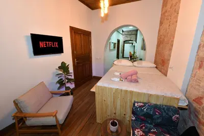 a bedroom with a bed and a chair and a mirror at Wooden Style AC Galata in Istanbul