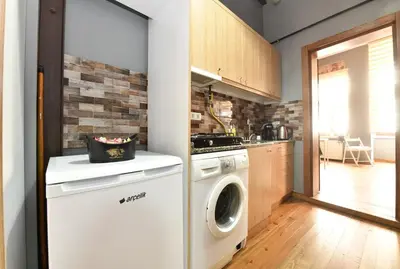 a kitchen with a washer and dryer in a room at Historical Wooden Style AC in Beyoğlu Galata in Istanbul