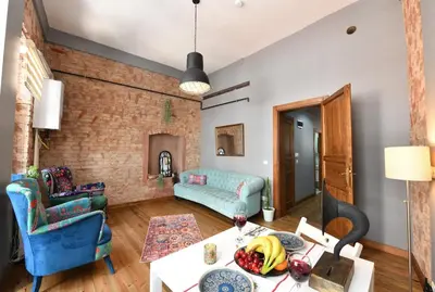 a living room with a couch and a table at Historical Wooden Style AC in Beyoğlu Galata in Istanbul