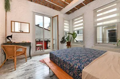 a bedroom with a bed and a desk and windows at 2BR Unique Terrace 2 AC in Beyoğlu Galata in Istanbul