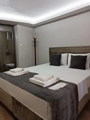 a bedroom with a large bed with towels on it at Mesil Hotel in Istanbul