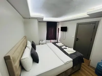 a bedroom with a large white bed in a room at Mesil Hotel in Istanbul