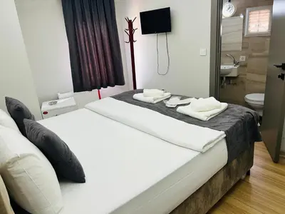 a hotel room with two beds and a bathroom at Mesil Hotel in Istanbul