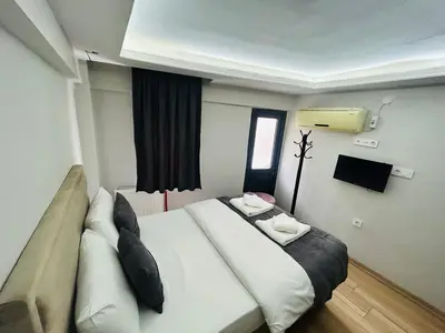 a hotel room with a large white bed and a window at Mesil Hotel in Istanbul