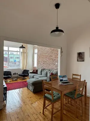 a living room with a table with a laptop on it at The Kinyas House - Apartment in Kadıköy Historical Fishermen's Market in Istanbul