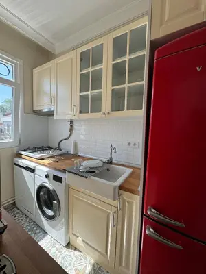 a kitchen with a sink and a washing machine at The Kinyas House - Apartment in Kadıköy Historical Fishermen's Market in Istanbul