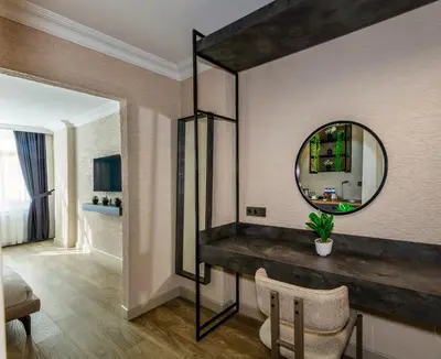 a room with a mirror and a table and chairs at Çorlu Temel Hotel in Corlu