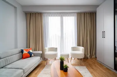 a living room with a couch and a table and chairs at Pia Homes- Gümüşsuyu in Istanbul