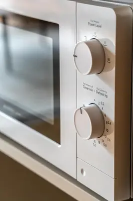 a microwave oven with two knobs on it at Pia Homes- Gümüşsuyu in Istanbul