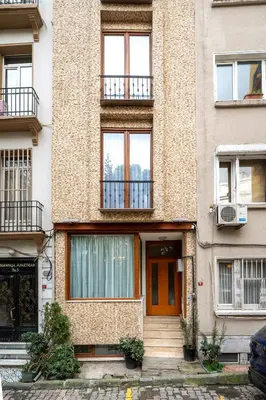 an apartment building with a staircase in front of it at Pia Homes- Gümüşsuyu in Istanbul