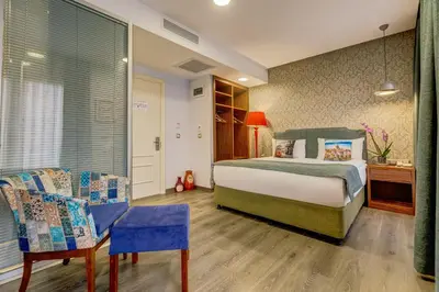 a bedroom with a bed and a table and chairs at Sometimes Hotel Taksim in Istanbul
