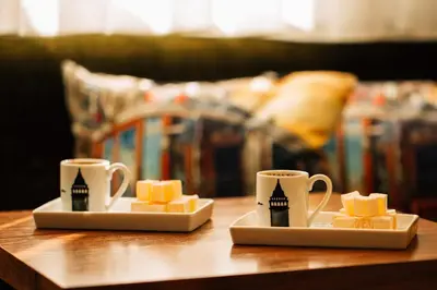 two cups of coffee and cheese on a table at Sometimes Hotel Taksim in Istanbul